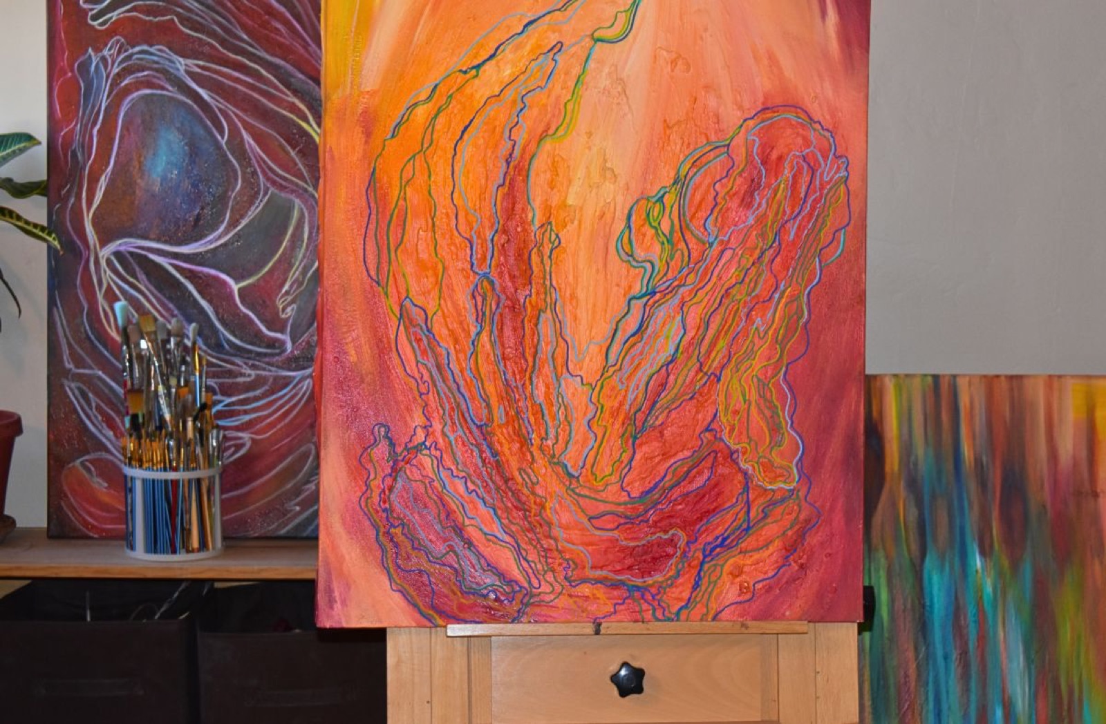 Work in progress on the easel among brushes in Diane's studio